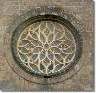 rose window of the church closed by opaque glass and decorated with metal ornaments