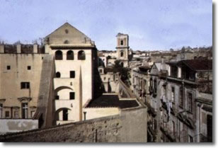 glimpse of the old town centre with a bell tower in the background